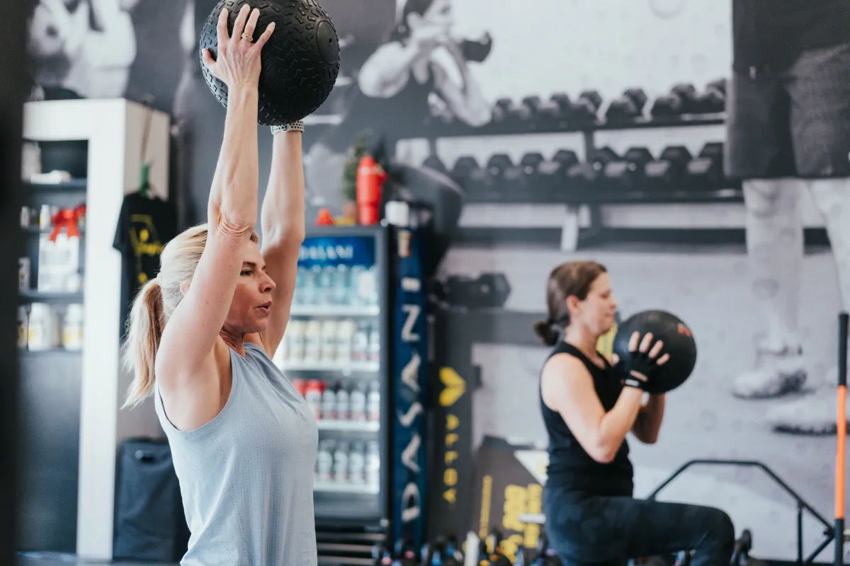 Coach guiding a strength training session at Alloy Personal Training in Edina, MN
